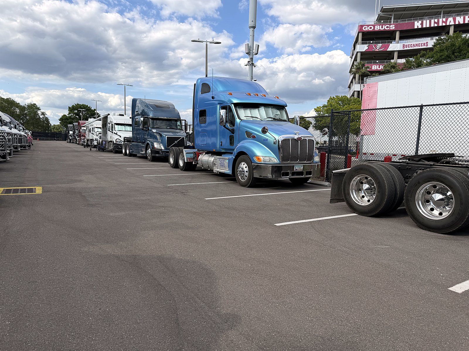 Blue CW Peterbilt in a stadium lot